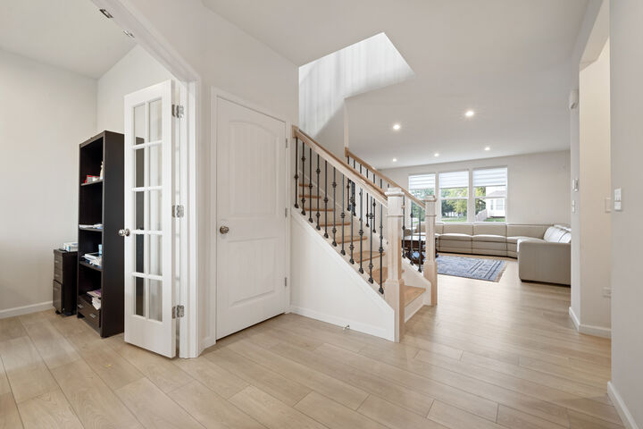 The foyer, with the office behind French doors on the left.
