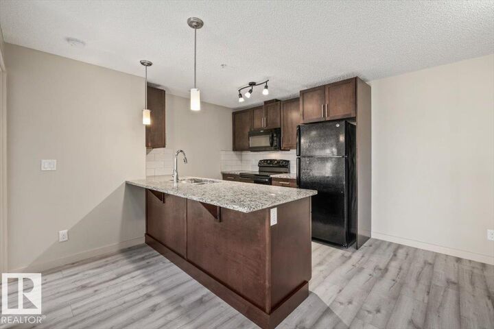 Property Photo: 6076 Schonsee Way NW 230 AB T5Z 0K8